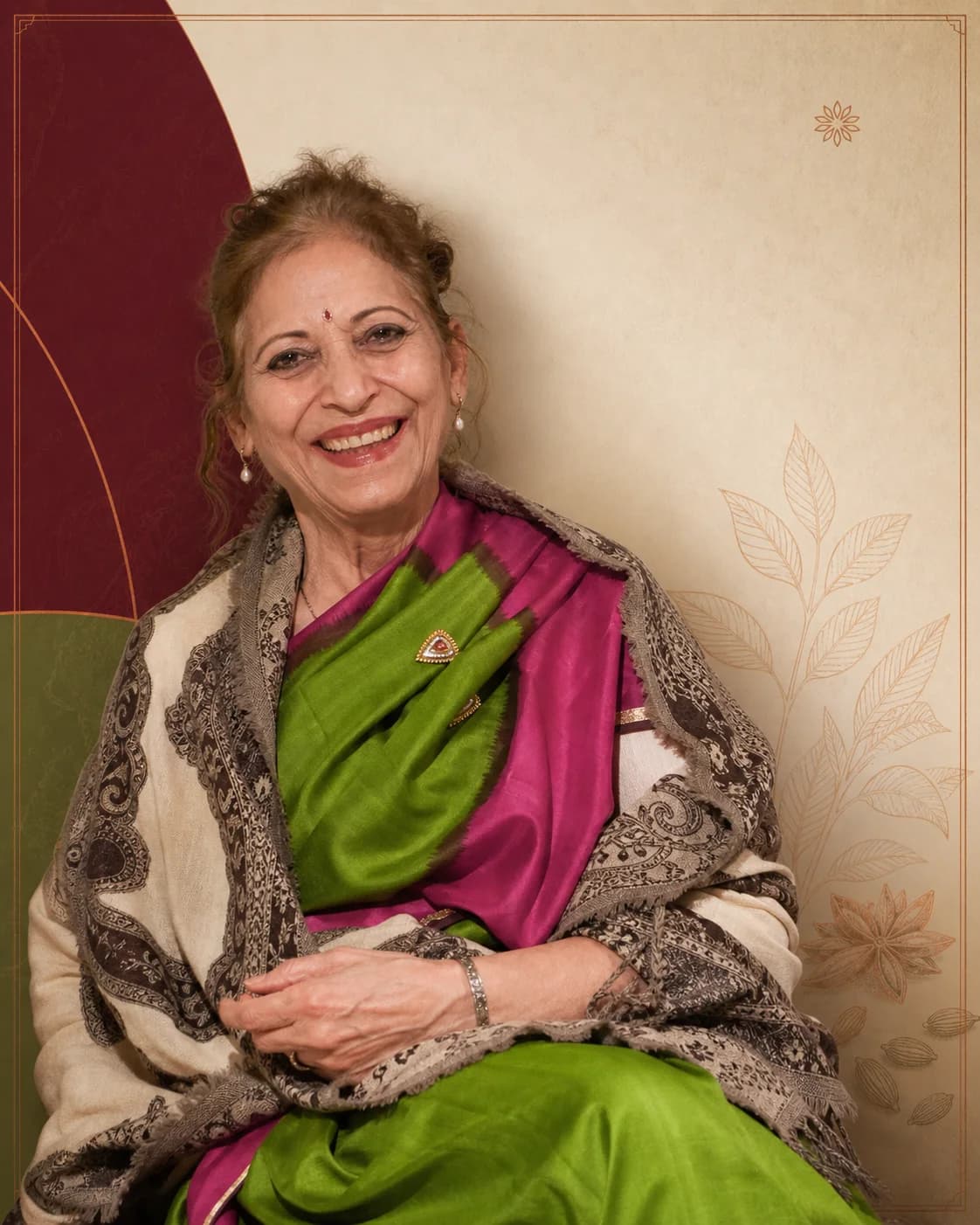 Aradhana Anna Parmar smiling in a green and magenta sari